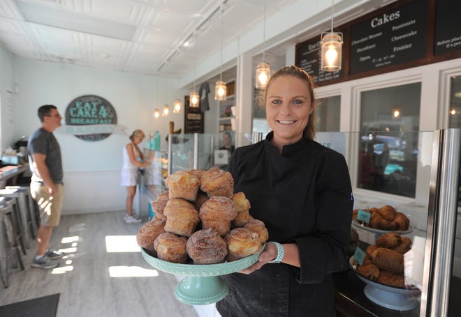 Danielle Nettleton holds a platter of Brewster Buns, one of her specialties at Eat Cake 4 Breakfast Bakery. Her business was closed for a few weeks this spring after a driver crashed through part of her building. [Merrily Cassidy/Cape Cod Times]