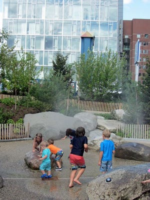 Kids have a great time with the water sprays at the new Martin Richard’s Park near the Children’s Museum.