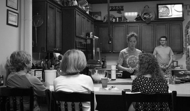 Lori Peifer teaches a cooking class at her store on Monday, July 22. MONTANA SAMUELS | PEKIN DAILY TIMES