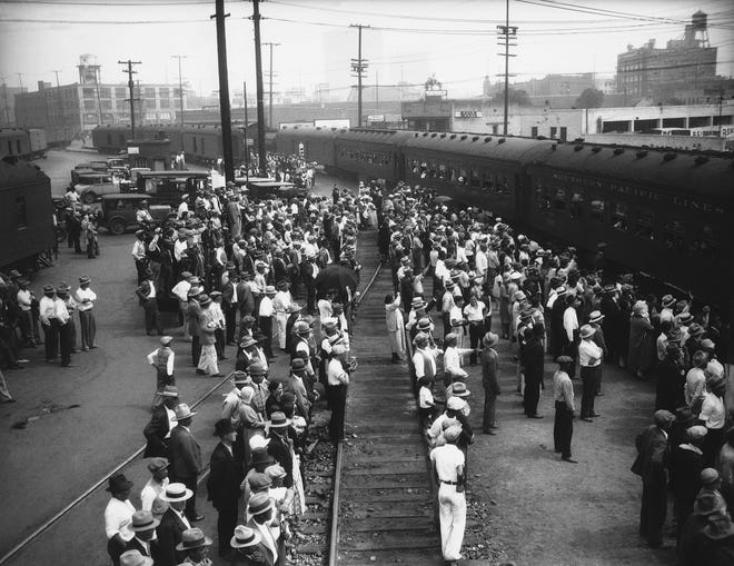 Some of the 1,300 Mexicans sent back to their native country by the Los Angeles County Charities Department at Los Angeles on Aug. 21, 1931. Unable to continue the support of dependent Mexicans, the department sent the foreigners away in two special sections. The Mexicansí food, clothing and train tickets were paid for by the county. [The Associated Press]