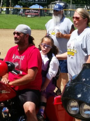 Seven-year-old Mia Gaumer, middle, of St. Marys, has been attending the Hogs Softball Tournament since she was 3 years old. The tournament raises money every year for Camp Milton, a summer camp for children like Gaumer, who have muscular diseases. [Submitted]