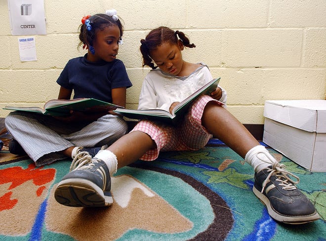 First graders spend time reading in their class. [AP FILE PHOTO BY DAVE MARTIN]