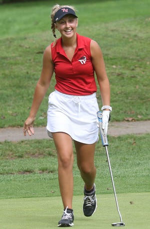 Abbey Dillon of Tusky Valley walks to get her ball from the hole after making a eagle putt on the first hole at Wilkshire Golf Course Wednesday during a match with Indian Valley. (TimesReporter.com / Jim Cummings)