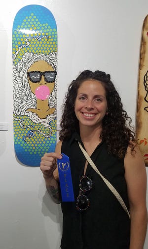 Sara Griffiths poses with her first-place piece, "Curly-Pop." [CONTRIBUTED PHOTOS]