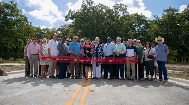 Bastrop city officials along with the Bastrop Economic Development Corporation and the Bastrop Chamber of Commerce hosted a ribbon cutting ceremony for the Agnes Street extension from Texas 304 to the eastern stretch of the property of the forthcoming Seton hospital in Bastrop. [PHOTO BY CHRIS WHITE, BASTROP CHAMBER OF COMMERCE]