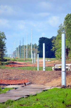 Power poles go up for the 138kv line along Vincent Road in Girard Township. [Don Reid photo]