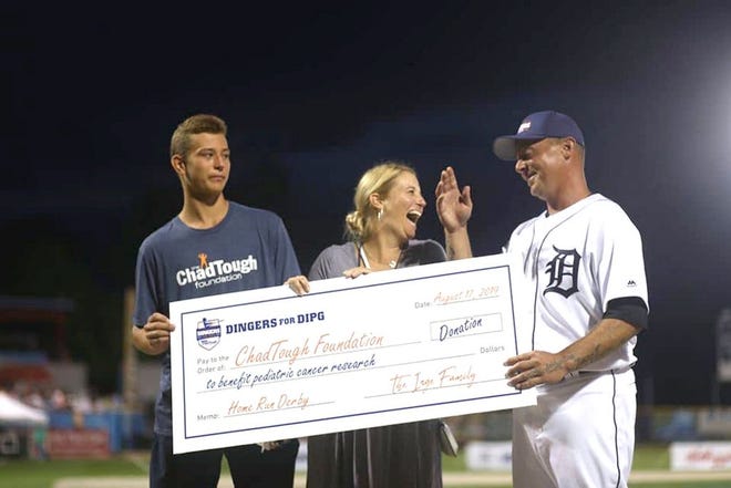 Former Detroit Tiger Brandon Inge presents a donation check to the ChadTough Foundation after the Dingers for DIPG event.