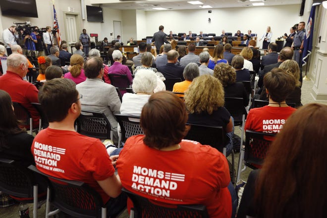 Attendees wear shirts during the second day of a Virginia Crime Commission meeting on gun issues at the Capitol in Richmond, Va., Tuesday, Aug. 20, 2019. Democratic Gov. Ralph Northam called the special session after a city employee opened fire in a Virginia Beach municipal complex May 31. (AP Photo/Steve Helber)