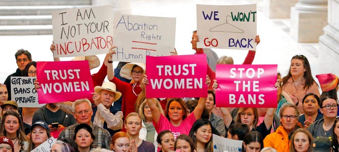 FILE - In this May 21, 2019, file photo, activists gather in the Utah State Capitol Rotunda to protest abortion bans happening in Utah and around the country, in Salt Lake City. About 39,000 people received treatment from Planned Parenthood of Utah in 2018 under a federal family planning program called Title X. The organization this week announced it is pulling out of the program rather than abide by a new Trump administration rule prohibiting clinics from referring women for abortions. (AP Photo/Rick Bowmer)