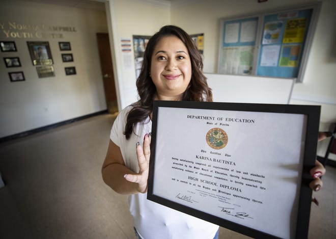 Karina Bautista received her high school diploma through The Family Literacy Academy at Lake Wales GED program on Wednesday. Some students struggle to make it out of high school. Places like the Family Literacy Center and New Beginnings High School in Winter Haven help them to succeed. [ERNST PETERS/THE LEDGER]