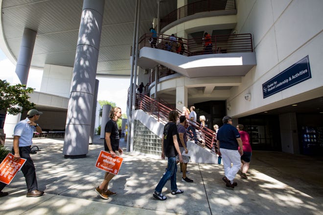In this May 21 photo, protesters file into a building for the Board of Trustees meeting to talk about the need for Santa Fe College adjunct faculty to have a union. [Gainesville Sun File]