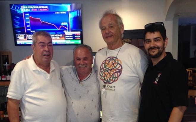 Bill Murray poses for a photo with patrons and staff at Cafe Mimo in New Bedford. [Courtesy of Cafe Mimo]