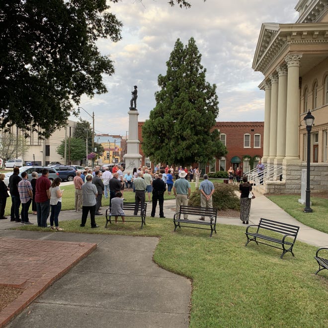 People gather on the lawn of the 1909 Historic Courthouse on Aug. 15 to pray and hear Pastor Bryant Madren of Brower’s Wesleyan Church. [CONTRIBUTED PHOTO]
