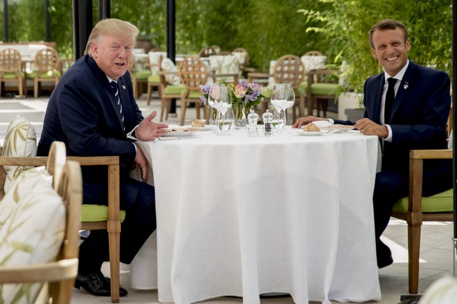 President Donald Trump and French President Emmanuel Macron sit together for lunch at the Hotel du Palais in Biarritz, France, on Saturday. Efforts to salvage consensus among the Group of Seven rich democracies on the economy, trade and environment were fraying around the edges even as leaders were arriving before their three-day summit in southern France. [ANDREW HARNIK/THE ASSOCIATED PRESS]