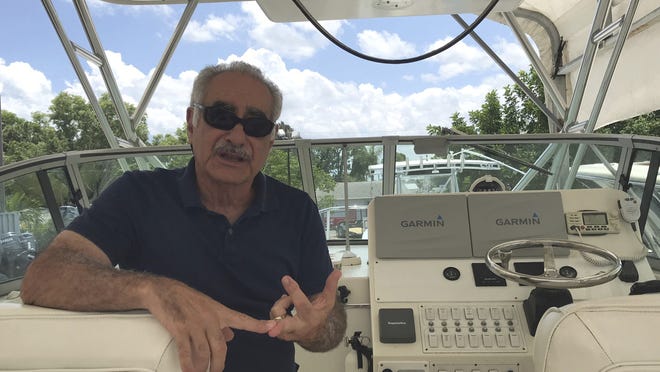 George Haddad, of Palm City, whose boat was hit by lightning Saturday, Aug. 10, talks about his experience from sitting inside the boat as it's dry-docked for inspection in Martin County. [Sara Marino/TCPalm.com via the Associated Press]