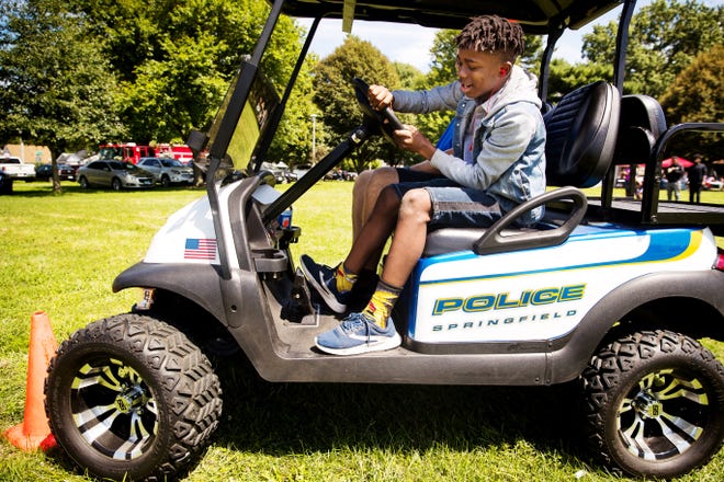 Earl Clark can't get around an orange pylon as he gets a chance to drive a golf cart with Springfield Police Officer Mike Burmeister during The Outlet's annual Bridging the Gap BBQ Saturday, Aug. 24. [Ted Schurter/The State Journal-Register]
