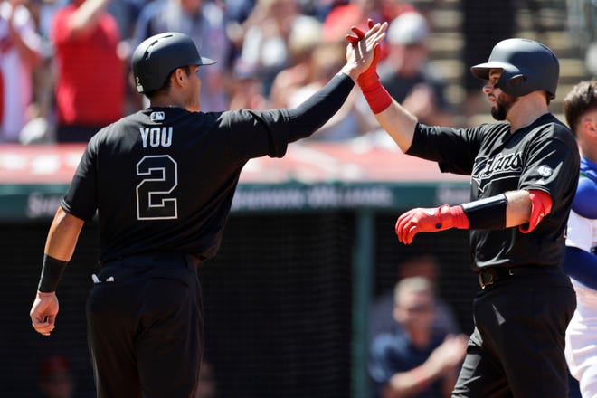 Cleveland Indians' Kevin Plawecki, right, and Yu Chang celebrate after Plawecki hit a two-run home run in the third inning of a baseball game, Sunday, Aug. 25, 2019, in Cleveland. Chang scored on the play. (AP Photo/Tony Dejak)