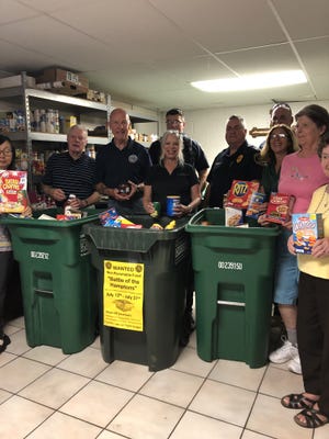 Pictured, showing the foods collected in the three-week drive, from left, are Ed Shannon, a Lower Southampton supervisor; Ray Weldie, chairman of the Lower Southampton supervisors; Deborah Kaplan, a township supervisor, police Sgt. Matthew Bowman; police Chief Ted Krimmel; Lisa Adams, Lower Southampton personnel administrator and food drive coordinator; police Lt. Michael Pennington and volunteers from Assumption Church. [CONTRIBUTED]