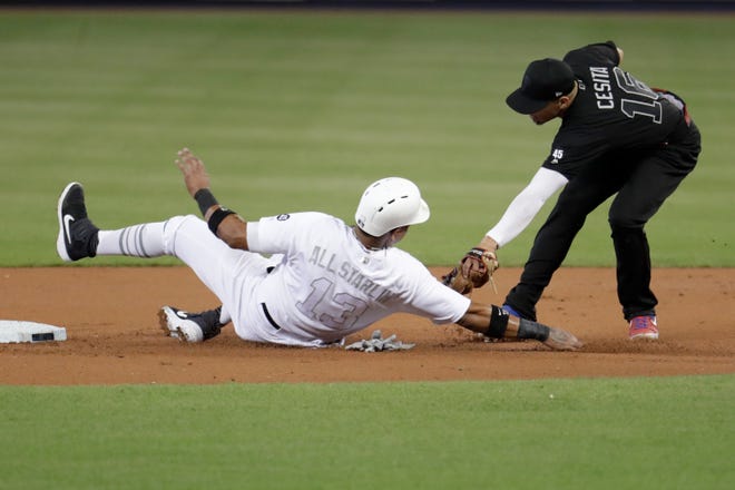 Miami Marlins' Starlin Castro is tagged out by Philadelphia Phillies second baseman Cesar Hernandez while trying to stealing second during the first inning Sunday's game. [Lynne Sladky / Associated Press]