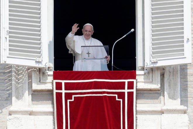 Pope Francis waves to faithful during the Angelus noon prayer in St. Peter's Square at the Vatican on Sunday. The pontiff said the Amazon forest is vital for our Earth and is urging prayers that fires there are quickly controlled. Francis added his voice Sunday to the chorus of international concern that the blazes in Brazil will have grave repercussions on the world's environmental health.