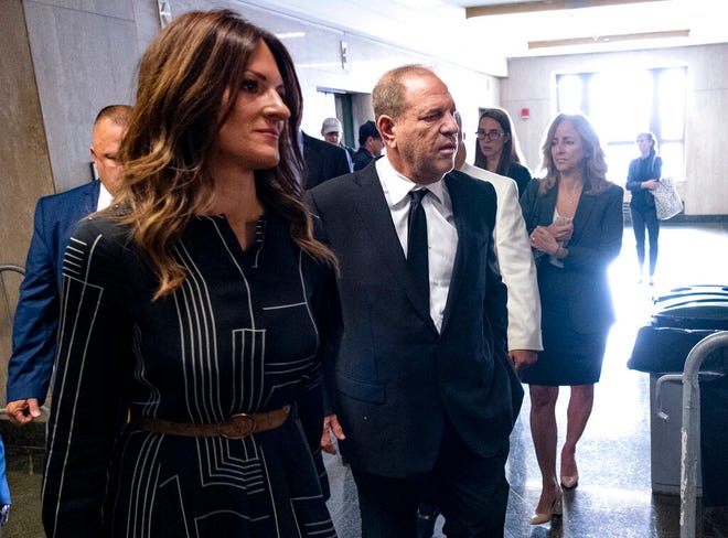 Harvey Weinstein, center, appears in a courthouse for a scheduled arraignment Monday, Aug. 26, 2019, in New York. Weinstein's lawyers want the trial moved from New York City to Long Island or upstate New York, part of the last-minute wrangling that includes efforts by prosecutors to bolster their case with testimony from actress Annabella Sciorra, who says Weinstein raped her in the 1990s. Weinstein has denied all accusations of non-consensual sex. (AP Photo/Craig Ruttle)