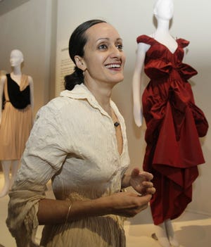 FILE - In this June 15, 2009 file photo fashion designer Isabel Toledo is shown at a retrospective exhibit of her work at the Fashion Institute of Technology Museum in New York. Toledo, the Cuban-American fashion designer with an avant-garde flair who created former first lady Michelle Obama's standout lemongrass-colored sheath dress and matching overcoat for her husband's 2009 inauguration, has died. She was 59. [AP Photo/Kathy Willens, File]
