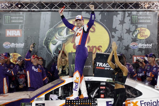 Denny Hamlin, center, celebrates after winning a NASCAR Cup Series race on Aug. 17 in Bristol, Tenn. [AP Photo/Wade Payne]