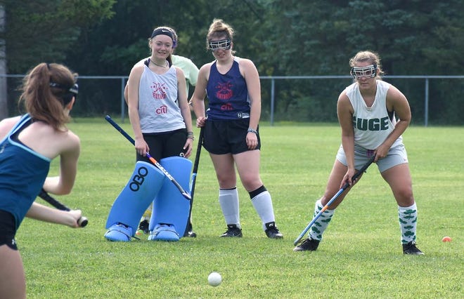 Little Falls Mountie Lindsay Slaboc (right) awaits a pass from fellow senior Emily Gehring with classmates Hannah Young and Erin Manley (from left) looking on during the season's first field hockey practice Aug. 19 at Veterans Memorial Park. The Mounties have a scrimmage at home Tuesday morning against Central Valley Academy.      

[JON RATHBUN/TIMES TELEGRAM]