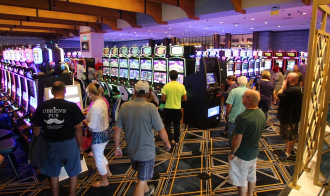 Patrons walk around the Tiverton Casino floor on its opening day, Sept. 1. [PROVIDENCE JOURNAL FILE PHOTO]