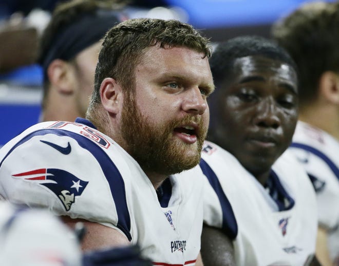 The Patriots' Ted Karras, on the bench during the Aug. 8 preseason game against the Lions, is expected to take over the starting center position in place of the sidelined David Andrews. [AP / Duane Burleson]