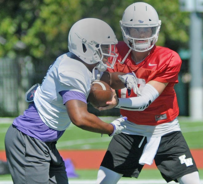 Kansas Wesleyan quarterback Johnny Feauto hands off to running back Demarco Prewitt during a recent practice at the Graves Family Sports Complex. Feauto was the KCAC co-offensive player of the year and Prewitt the player of the year last season. [AARON ANDERS/SALINA JOURNAL]