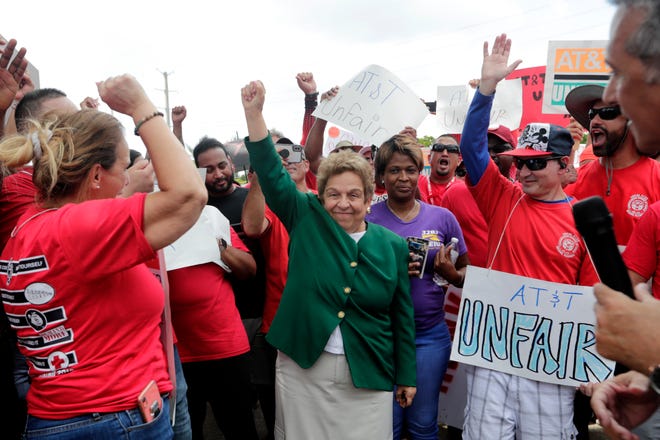 Miami Rep. Donna Shalala, center, stands with members of the Communications Workers of America (CWA) as they walk a picket line outside of an AT&T office Monday in Miami. CWA union members in the southeast went on strike Friday over unfair labor practices by management during negotiations for a new contract. [Lynne Sladky/The Associated Press]