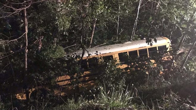 A bus carrying students from Thomas Jefferson Classical Academy went down a 30-foot embankment Monday night. [Photo courtesy of Stephanie Santostasi / WSOC TV]