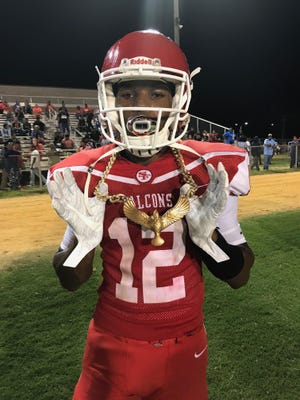 Defensive back Jalen Blue, who had an interception return for a touchdown against Westover on Monday, shows off Seventy-First's "turnover chain." The Falcons had five takeaways in the victory. [Rodd Baxley/The Fayetteville Observer]