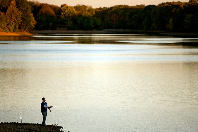 Casey Jacoby of Greenfield tries his hand at fishing as the sun sets on Lake Storey. [REGISTER-MAIL FILE PHOTO]