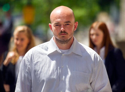 FILE - In this June 11, 2014 file photo, former Blackwater Worldwide guard Nicholas Slatten leaves federal court in Washington, after the start of his first-degree murder trial.  A federal judge has sentenced a former Blackwater security contractor to life in prison for his role in the 2007 shooting of unarmed civilians in Iraq. (AP Photo/Cliff Owen)