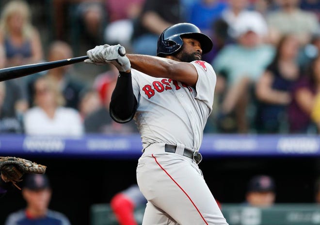 Boston's Jackie Bradley Jr. follows through on a solo home run off Colorado Rockies starting pitcher Rico Garcia during the second inning Tuesday night.