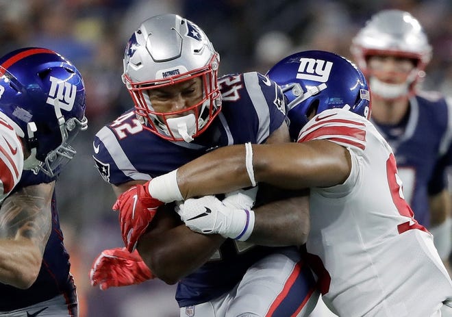 New York Giants middle linebacker B.J. Goodson, right, tackles Patriots running back Nick Brossette during Thursday's NFL preseason game in Foxborough, Mass. [AP photo]