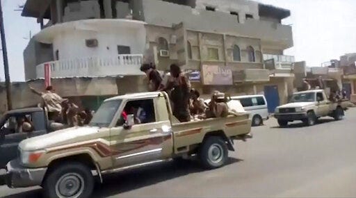 In this frame grab from video provided by Yemen Today, Yemeni army vehicles enter Zinjibar, Yemen, Wednesday, Aug. 28, 2019. Yemeni officials and local residents say forces loyal to the country's internationally recognized government have wrested control of the capital of southern Abyan province from separatists backed by the United Arab Emirates. They say government forces on Wednesday pushed the UAE-backed militia, known as the Security Belt, out of Zinjibar after clasher that left at least one dead and 30 wounded fighters. (Yemen Today via AP)