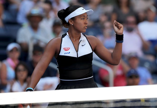 Naomi Osaka reacts after defeating Magda Linette during the second round of the US Open on Thursday in New York. [Eduardo Munoz Alvarez/The Associated Press]