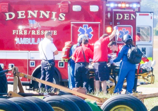Rescue personnel prepare a man who was shot in a Dennis parking lot Friday for a MedFlight from Barnstable Municipal Airport in Hyannis to Massachusetts General Hospital in Boston. [Photo by David Curran]