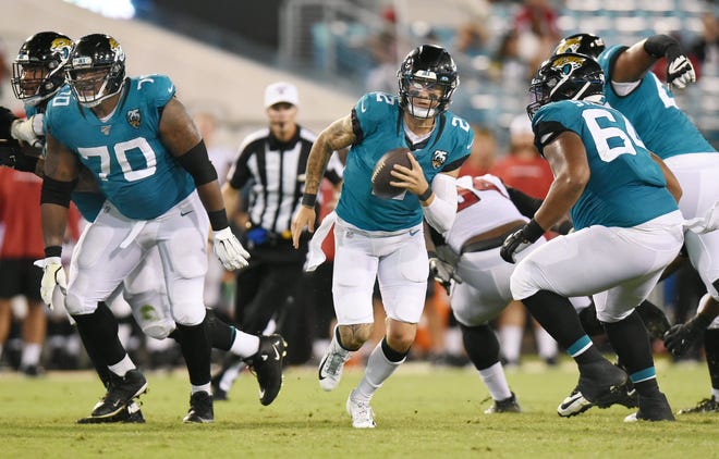 Jaguars quarterback Alex McGough finds a hole on a long scramble for a first down against Atlanta on Thursday night at TIAA Bank Field. [Bob Self/Florida Times-Union]