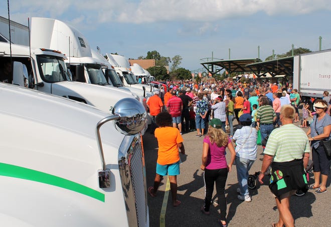 People gather around the trucks at the Holland Civic Center following the Holland/Zeeland Community Labor Day Truck Parade Monday, Sept. 5, 2016. Curtis Wildfong/Sentinel staff