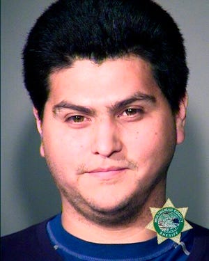 In this undated Multnomah County Sheriff photo is Antonio Scott Zamora. The Portland Police Bureau on Tuesday, Aug. 27, 2019, arrested another person in the aftermath of a protest and counter-protest that led to clashes between right-wing and left-wing demonstrators. Court documents say Antonio Scott Zamora was in a crowd of masked anti-fascist demonstrators who surrounded a bus carrying the far-right groups Proud Boys and Patriot Prayer. Authorities say Zamora, who was later identified by his teal-colored shirt and rainbow-colored face mask, hit the bus and threw an object at its window. Several videos of the attack on the bus, which was stopped in heavy traffic, went viral in the days after the Aug. 17 protest. (Portland Police Bureau via AP)