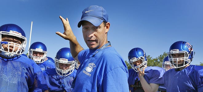 Coach Kevin Carey is working with his team's prospects.  The Quincy High Presidents football team practices at Faxon Field on Tuesday, August 20, 2019 Greg Derr/The Patriot Ledger