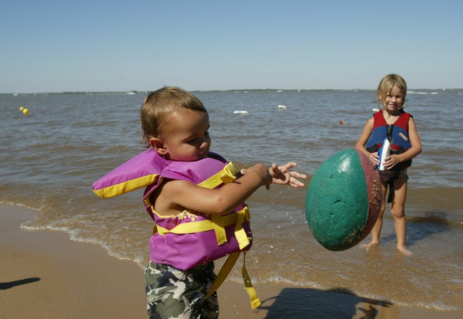 Ryan, 2, and Emma Harding, 5, play at Hobie Beach while enjoying Labor Day weekend at Cheney State Park. Ryan and Emma come to Cheney Lake with their parents Mike and Kristin Harding nearly every weekend during the summer. [Lindsey Bauman/Hutchinson News]