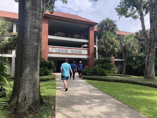 Students outside of the Lewis residence hall on Friday. Flagler College canceled classes through Wednesday, but the St. Johns County School District has yet to announce any closures. [Christen Kelley/The Record]