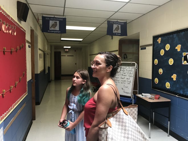 Iwona Wisniewska, right, and her daughter Clara peruse a bulletin board during a meet-and-greet at Sol Feinstone Elementary School in Upper Makefield Thursday. Clara is one of 84 students moving from Wrightstown ES to Sol Feinstone this year as the result of a Council Rock redistricting.

[CHRIS ENGLISH/STAFF PHOTOJOURNALIST]