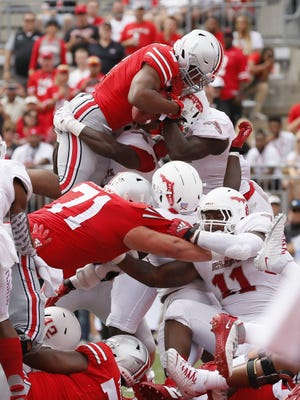 Running back J.K. Dobbins dives over the pile to score a 1-yard touchdown that gave Ohio State a 42-14 lead in the fourth quarter. [Adam Cairns/Dispatch]