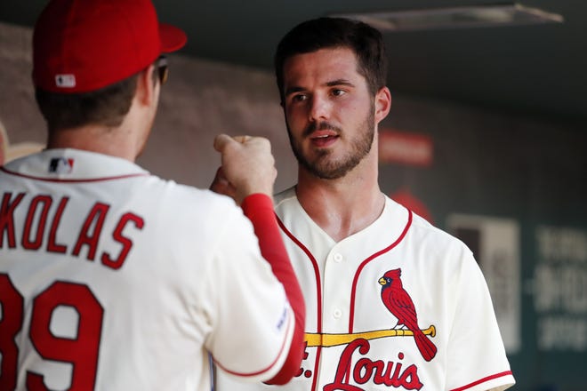 St. Louis Cardinals starting pitcher Dakota Hudson, right, is congratulated by teammate Miles Mikolas after being removed during the eighth inning in the first baseball game of a doubleheader against the Cincinnati Reds on Saturday in St. Louis. [Jeff Roberson/The Associated Press]